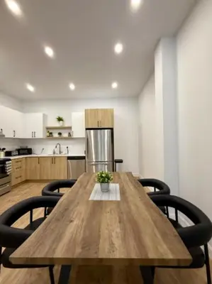 a wooden table with chairs in a kitchen at The Royale Apartments 1 in Trois-Rivières