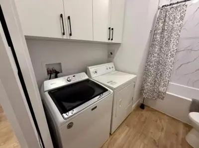 a small kitchen with a stove and a dishwasher at The Royale Apartments 1 in Trois-Rivières