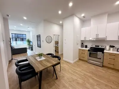 a kitchen and living room with a table and chairs at The Royale Apartments 1 in Trois-Rivières
