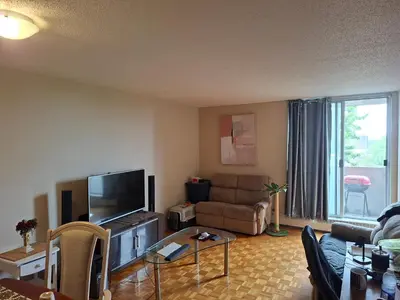 a living room with a couch and a flat screen tv at Nun island in Montréal