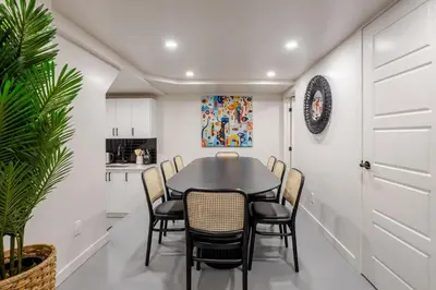 a dining room with a black table and chairs at Plateau Powerhouse 5BR and 2BA Apt in Montréal