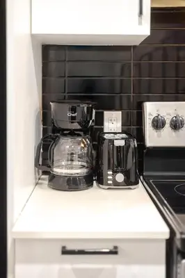a kitchen counter with a coffee maker on it at Plateau Powerhouse 5BR and 2BA Apt in Montréal