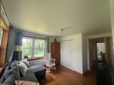 a living room with a couch and a window at Simple de nature in Austin