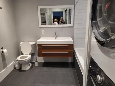 a bathroom with a toilet and a sink and a mirror at Super appartement proche metro in Montréal