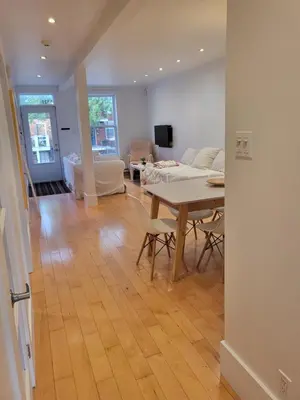 a living room with a table and a couch at Super appartement proche metro in Montréal