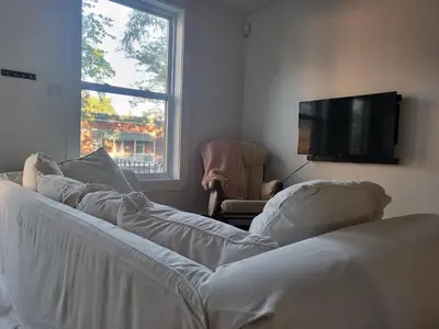 a living room with a couch and a flat screen tv at Super appartement proche metro in Montréal