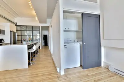 a kitchen with white appliances and a counter at Yulux Old Montreal luxurious apartments in Montréal