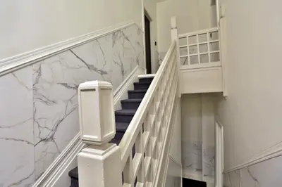 a white staircase with marble walls and white stair case at Yulux Old Montreal luxurious apartments in Montréal
