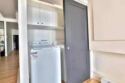 a laundry room with a washer and dryer in it at Yulux Old Montreal luxurious apartments in Montréal