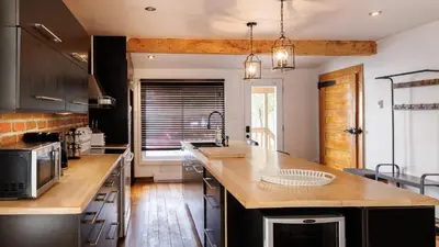 a kitchen with a wooden counter top in a room at Downtown Heritage House and Free Parking in Joliette