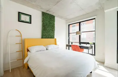 a bedroom with a large white bed and a desk at Old Port Gem - Charming 2 bdr in Prime Location in Montréal