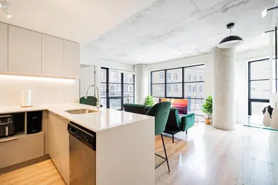 an open kitchen and living room in an apartment at Old Port Gem - Charming 2 bdr in Prime Location in Montréal