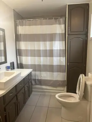 a bathroom with a toilet and a sink and a shower at le vétérans centrale in Lac-Mégantic