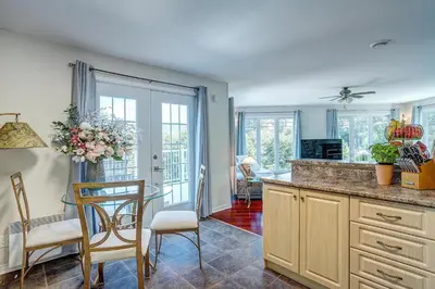 a kitchen with a table and chairs in a room at Sutton's montagne view in Sutton