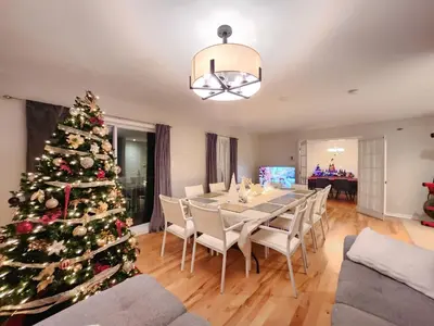 a christmas tree in a living room with a table and chairs at Sutton's montagne view in Sutton