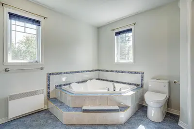 a bathroom with a tub and a toilet at Sutton's montagne view in Sutton