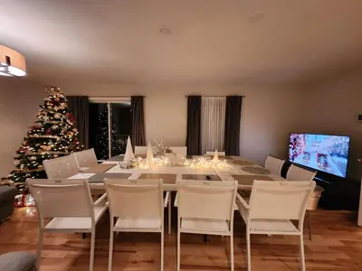 a dining room with a table and a christmas tree at Sutton's montagne view in Sutton