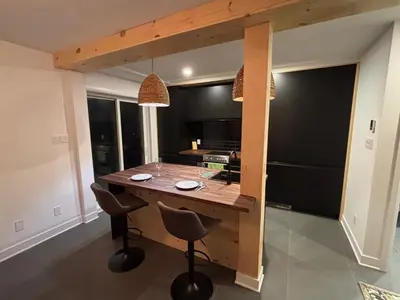 a kitchen with a wooden island in a room at Cosy Cabin apt in Montreal in Montréal
