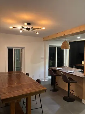 a dining room with a table and a ceiling fan at Cosy Cabin apt in Montreal in Montréal