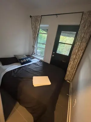a bedroom with a large bed with a window at Cosy Cabin apt in Montreal in Montréal