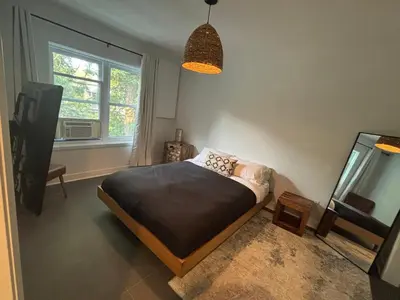 a bedroom with a bed and a flat screen tv at Cosy Cabin apt in Montreal in Montréal
