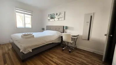 a bedroom with a bed and a desk and a chair at Private rooms in a shared three bedroom apartment in Montréal