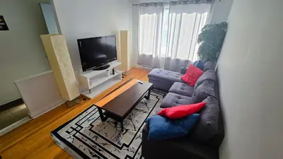 a living room with a couch and a table at Private rooms in a shared three bedroom apartment in Montréal