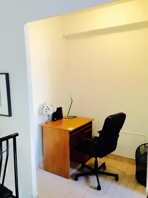 an office with a desk and a chair at Stylish Montreal Apartment Comfortable Stay in the Golden Square Mile in Montréal
