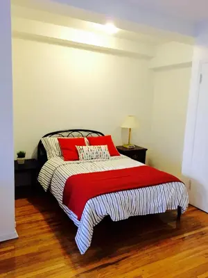 a bedroom with a bed with red pillows on it at Stylish Montreal Apartment Comfortable Stay in the Golden Square Mile in Montréal