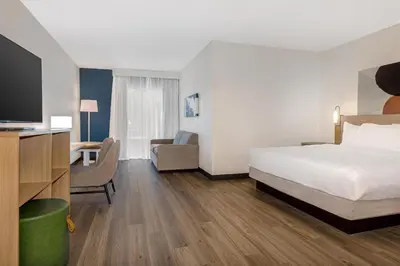 a hotel room with a bed and a desk at Spark By Hilton Montreal Midtown in Montréal