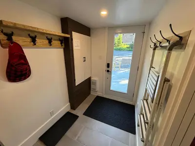 a hallway with a door leading to a room with a door at Spa - Chalet Sur Les Sentiers du Pic-Bois in Adstock