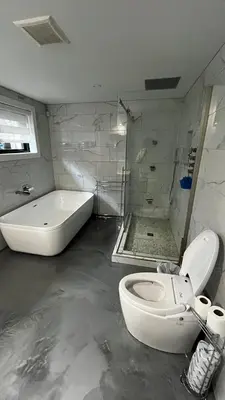 a bathroom with a toilet and a bath tub at Cozy Riverside Home Retreat in Laval