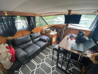a living room with a couch and a table with a laptop at Chalet Boat in the heart of Montreal in Montréal