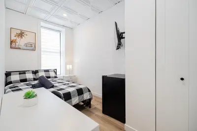 a living room with a bed and a couch at Room 1 - apartment 2 in a SHARED apartment in Montréal