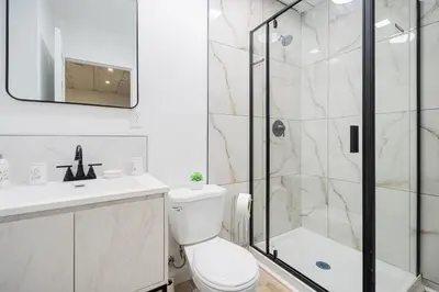 a bathroom with a shower and a toilet and a sink at Room 1 - apartment 2 in a SHARED apartment in Montréal