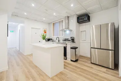 a kitchen with white counters and a refrigerator at Room 1 - apartment 2 in a SHARED apartment in Montréal