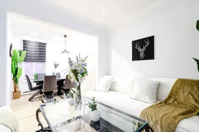 a living room with a white couch and a table at Royal Level-5 bedrooms avec 2 places de parking in Montréal