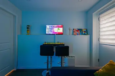 a blue room with two chairs and a tv on a wall at Royal Level-5 bedrooms avec 2 places de parking in Montréal