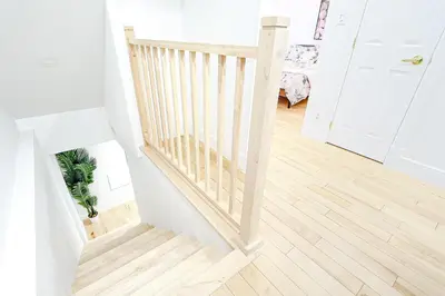 a staircase in a living room with wood floors at Royal Level-5 bedrooms avec 2 places de parking in Montréal