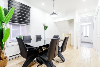 a dining room with a black table and chairs at Royal Level-5 bedrooms avec 2 places de parking in Montréal
