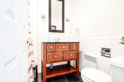 a bathroom with a wooden sink and a toilet at Royal Level-5 bedrooms avec 2 places de parking in Montréal