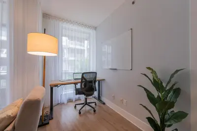 an office with a desk and a chair and a lamp at Modern Condo Old Town Montreal in Montréal
