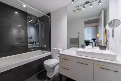 a bathroom with a sink and a toilet and a shower at Modern Condo Old Town Montreal in Montréal