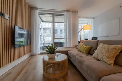 a living room with a couch and a table at Modern Condo Old Town Montreal in Montréal