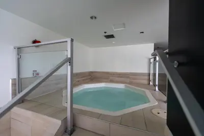 a hot tub in a room with a glass door at Modern Condo Old Town Montreal in Montréal