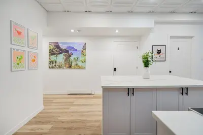 a kitchen with a counter and paintings on the wall at Chambre 2 - appartement 2 dans un appartement PARTAGÉ in Montréal