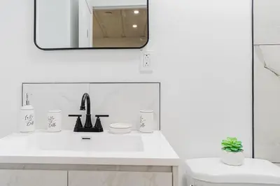 a white bathroom with a sink and a mirror at Chambre 3 - Appartement 2 dans un appartement PARTAGÉ in Montréal