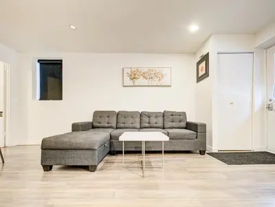 a living room with a couch and a table at Séjour agréable à Griffintown 2 chambres in Montréal