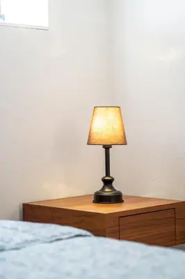 a lamp sitting on a table next to a bed at Séjour agréable à Griffintown 2 chambres in Montréal