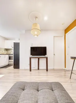 a living room with a couch and a table at Séjour agréable à Griffintown 2 chambres in Montréal